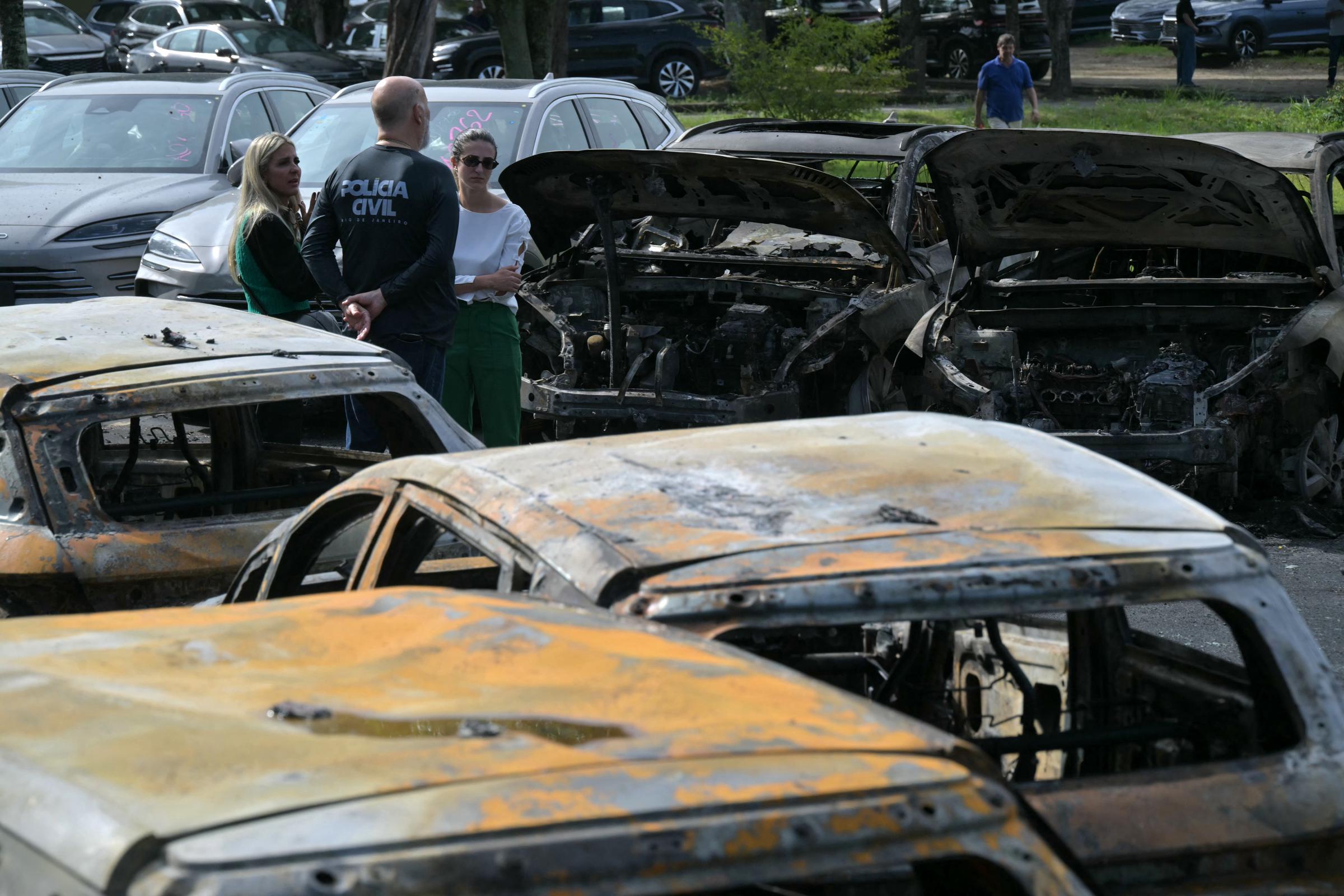 Investigators examined burned cars at the crash site after one of the helicopters crashed into a storage yard in Rio de Janeiro. Authorities said the impact sparked a fire that spread through the lot and damaged multiple vehicles. | Source: Getty Images
